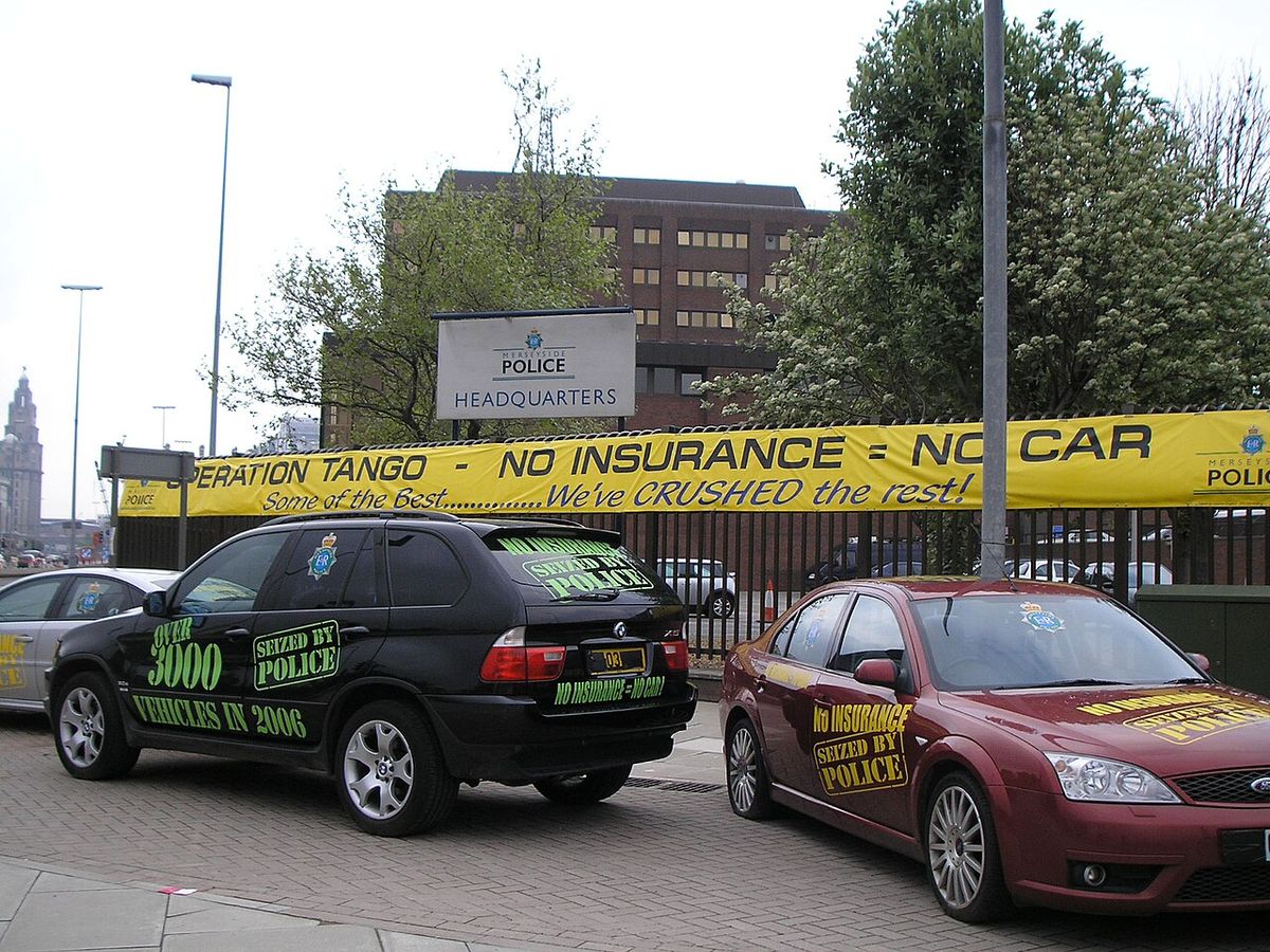 Uninsured cars seized by the Merseyside Police on display outside the force's headquarters in May 2006