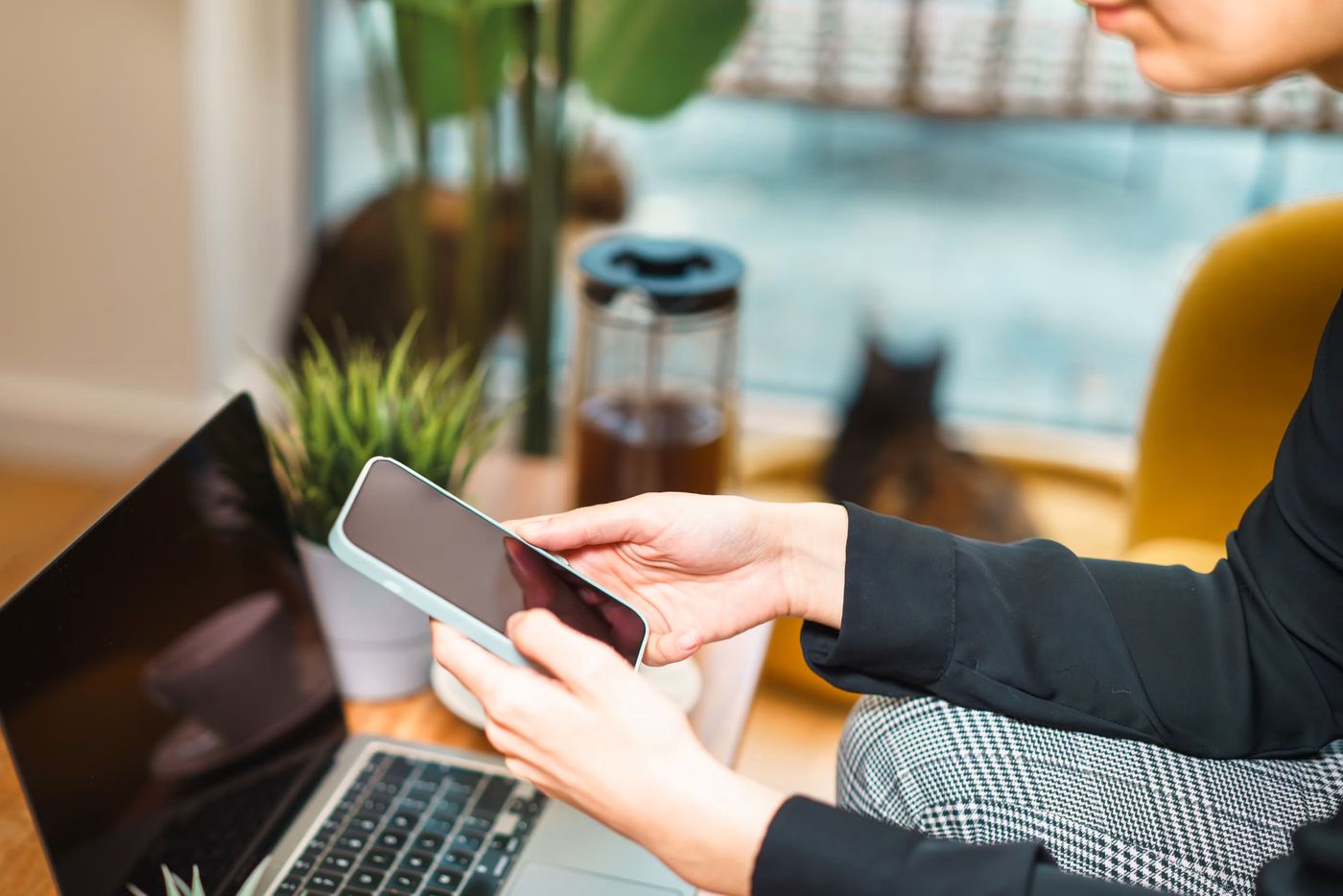 Person using a smartphone while working on a laptop, Free Photo on Unsplash