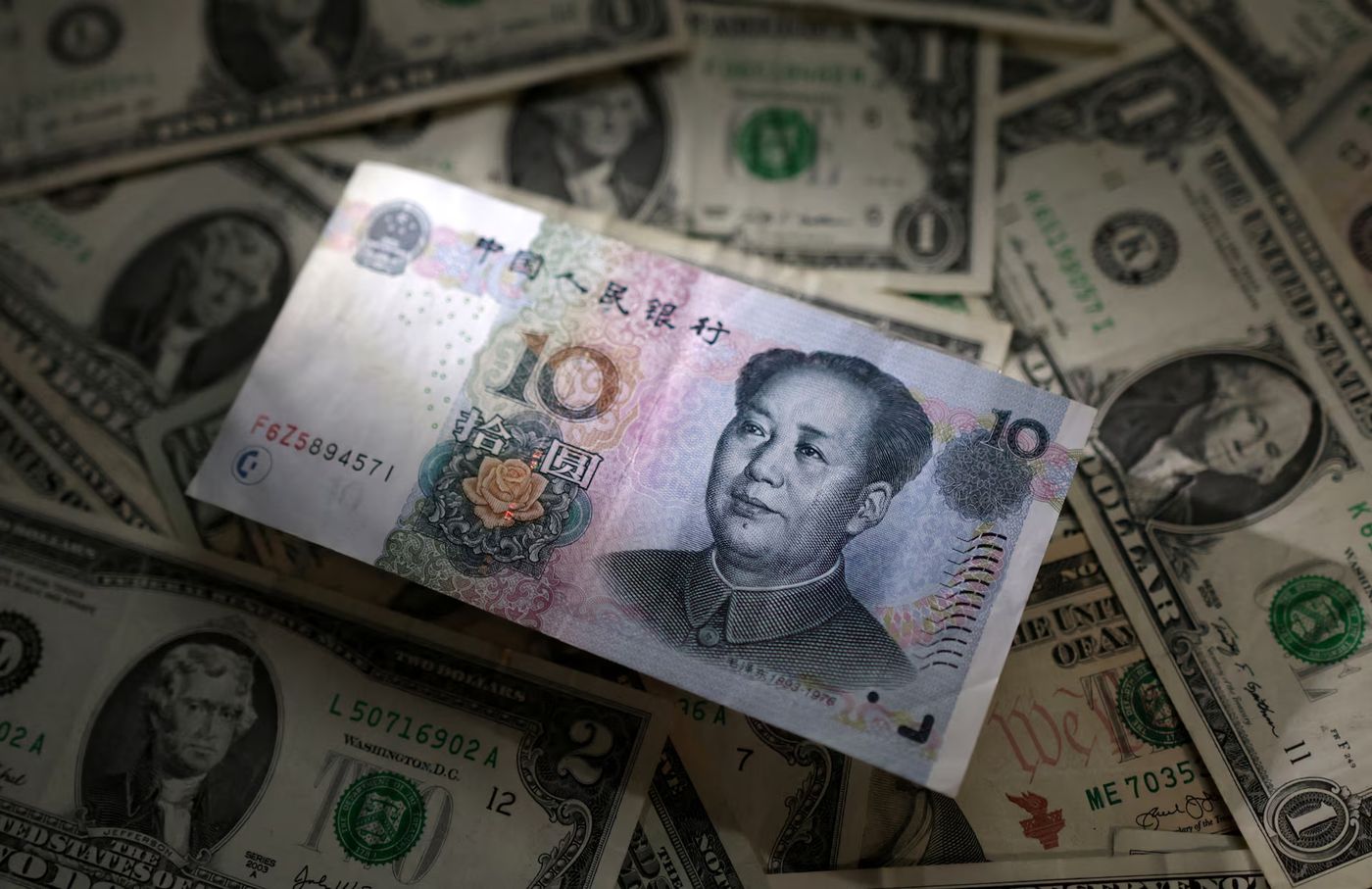 As China's yuan drops through 7 again, the dollar is in the driver's seat |  Reuters