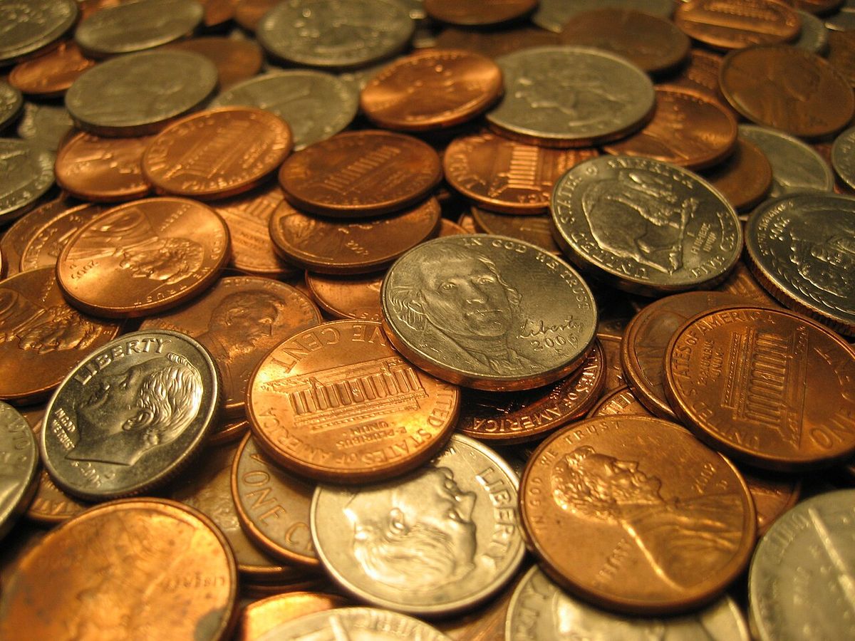 An assortment of United States coins, including quarters, dimes, nickels and pennies.
