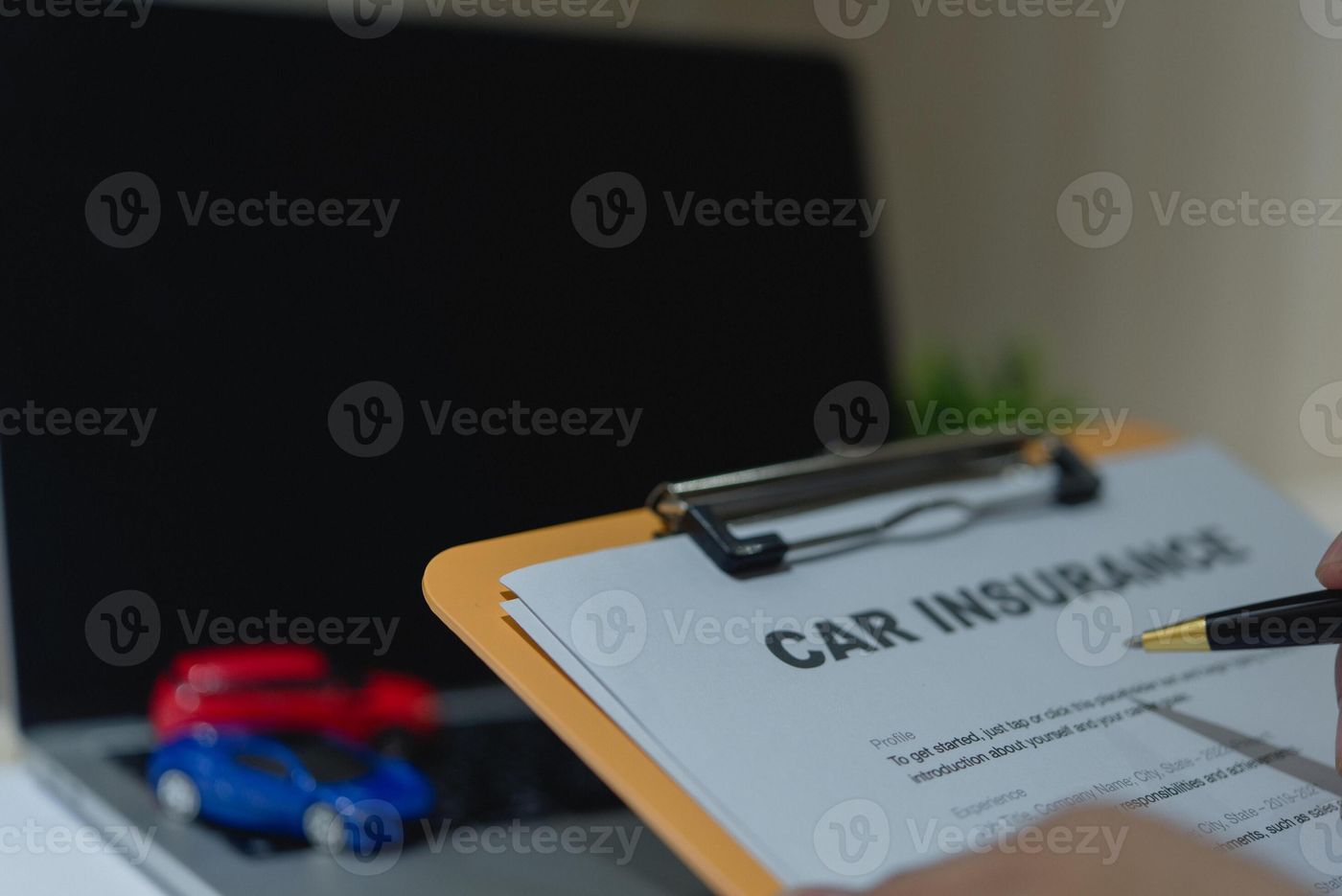 Close-up of a car insurance document, toy cars, and a clipboard on a work  desk. 48007285 Stock Photo at Vecteezy