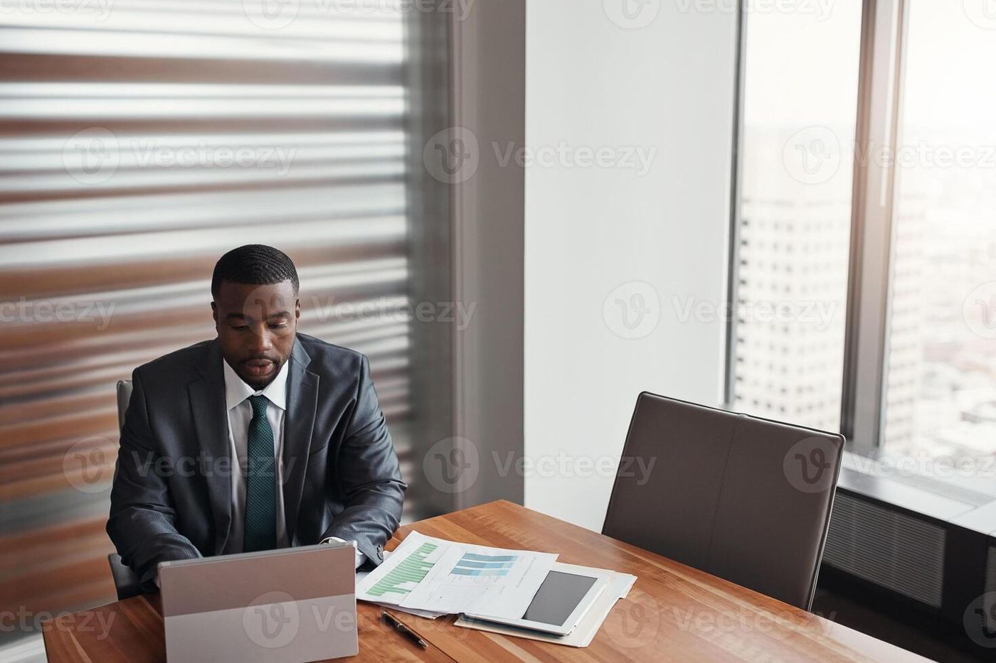 Black man, banker and laptop in office for finance, research and paperwork plan for growth. Male person, online proposal and review credit
