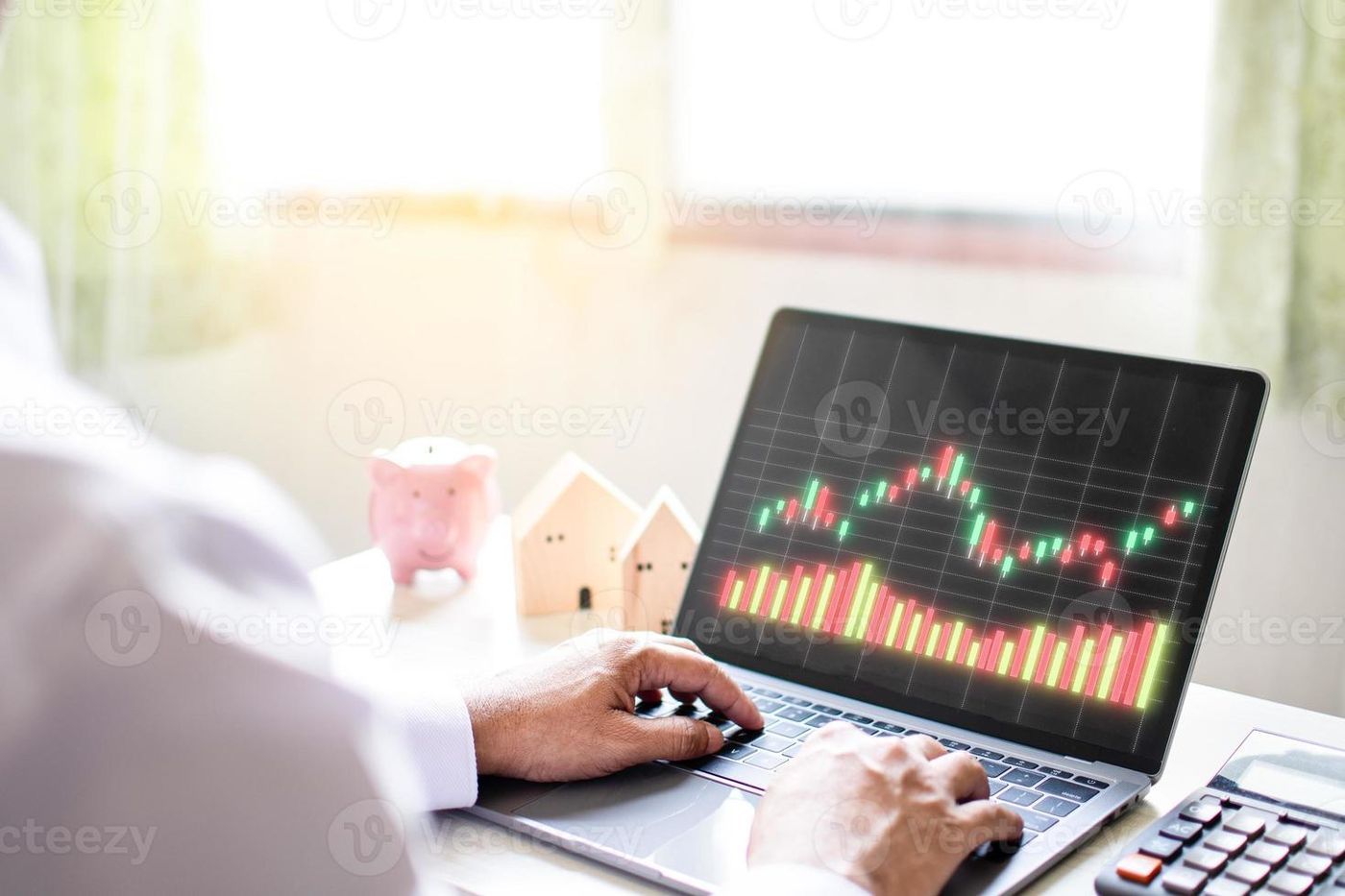Businessman working from home and alone with the stock market using a laptop  computer, analyzing trading data. Concept man tapping keyboard