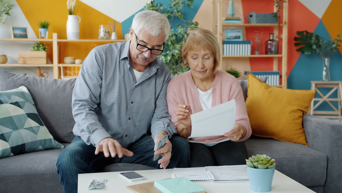 Elderly couple reviewing documents at home, Free Photo on Unsplash