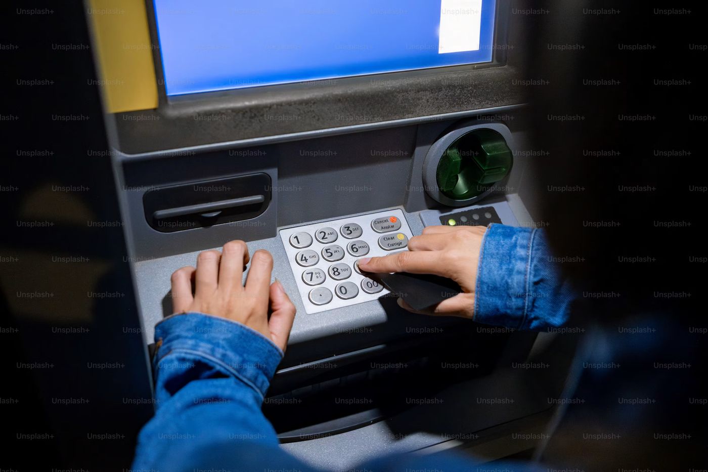 Person using a keypad on an atm machine, Photo on Unsplash+