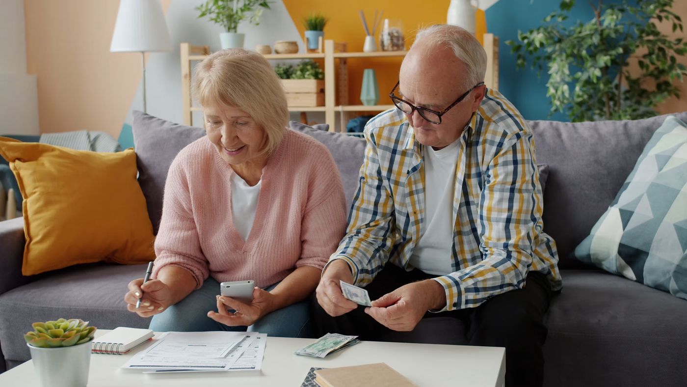 Elderly couple reviews finances at home on couch, Free Photo on Unsplash