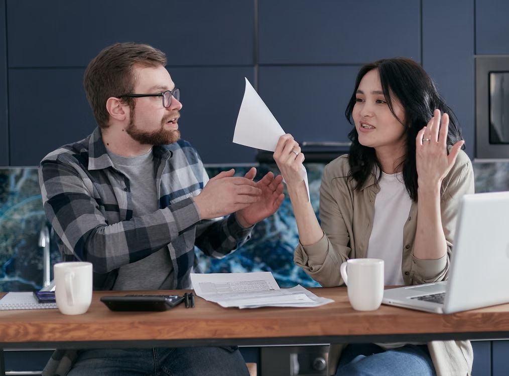 Couple Reviewing Financial Documents at Home · Free Stock Photo