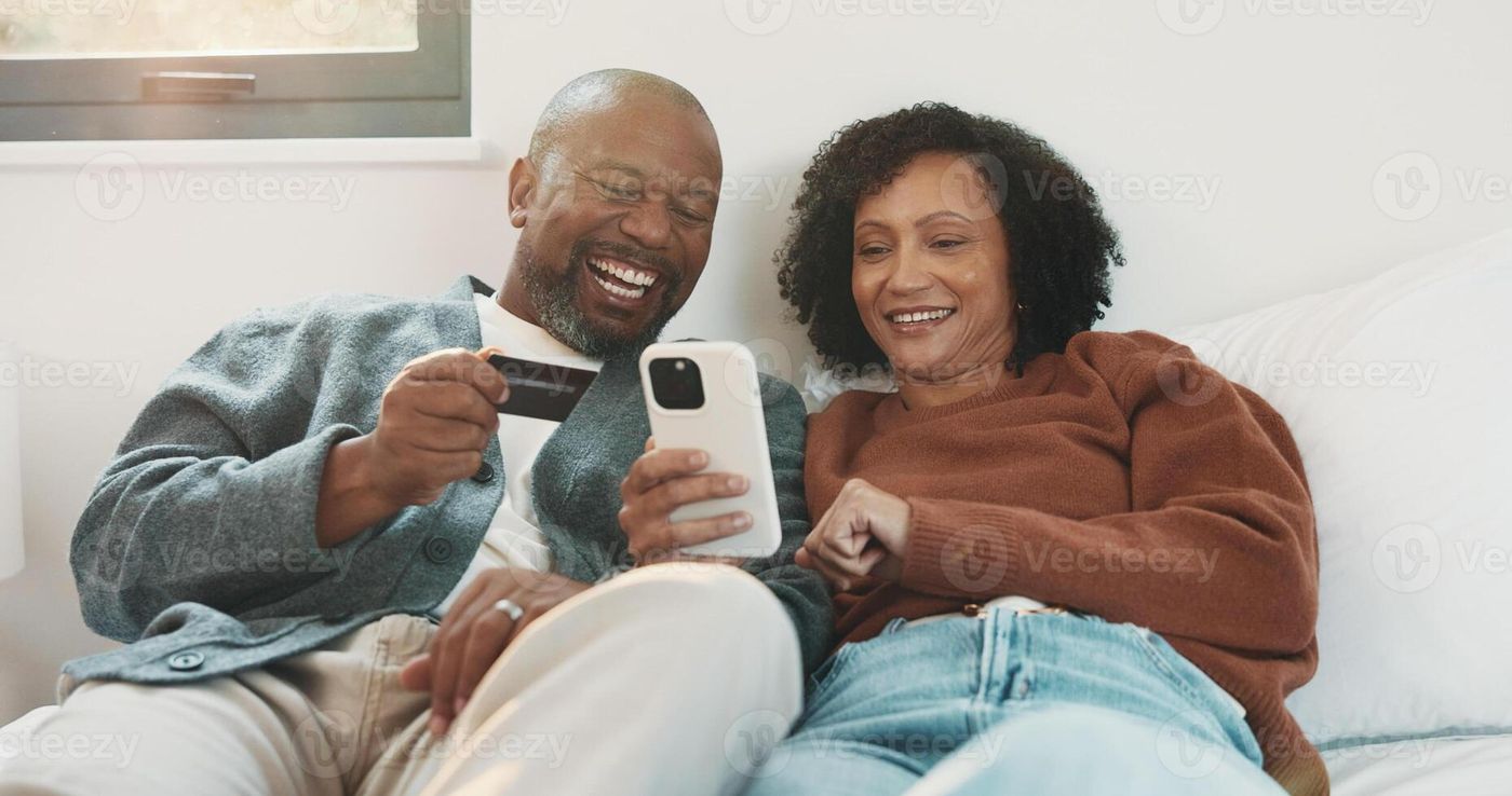 Couple, phone and credit card in home bedroom for online shopping,  subscription and payment. Laughing, African